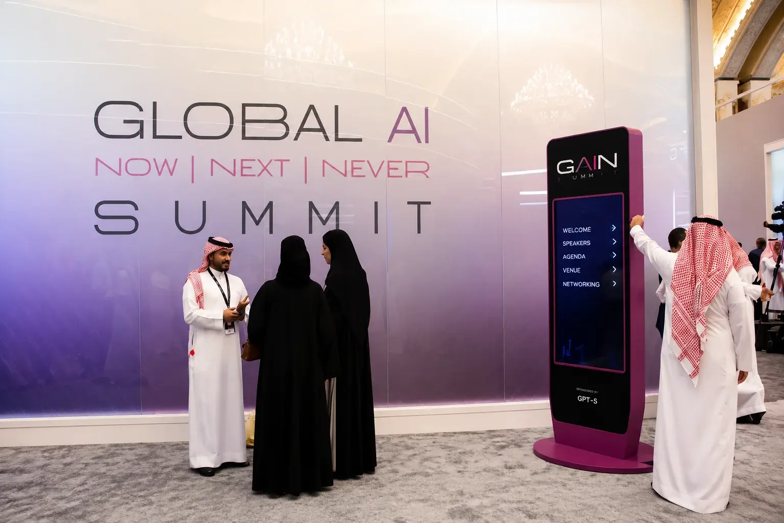 Attendees networking at the Global AI Summit wall